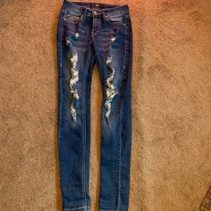 Dark colored ripped jeans